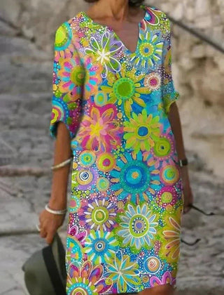 Nira vibrant floral midi dress by THE WHITMORE FAMILY featuring bright yellow fabric and a flowing, elegant design.
