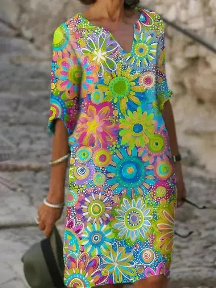 Nira vibrant floral midi dress by THE WHITMORE FAMILY featuring bright yellow fabric and a flowing, elegant design.