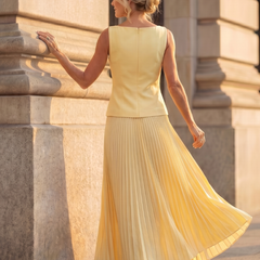 Yellow Rhodes structured bodice and pleated skirt set by THE WHITMORE FAMILY, stylish and elegant fashion ensemble.