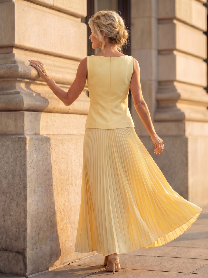 Yellow Rhodes structured bodice and pleated skirt set by THE WHITMORE FAMILY, stylish and elegant fashion ensemble.