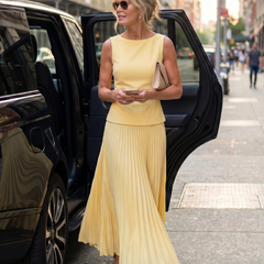 Yellow Rhodes structured bodice pleated skirt set by THE WHITMORE FAMILY, featuring a fitted top and matching high-waisted skirt.