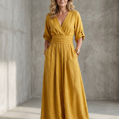 Yellow Wanda cross front wide leg jumpsuit by THE WHITMORE FAMILY, featuring a stylish front cross design and wide leg silhouette.