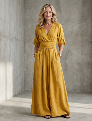 Yellow Wanda cross front wide leg jumpsuit by THE WHITMORE FAMILY, featuring a stylish front cross design and wide leg silhouette.