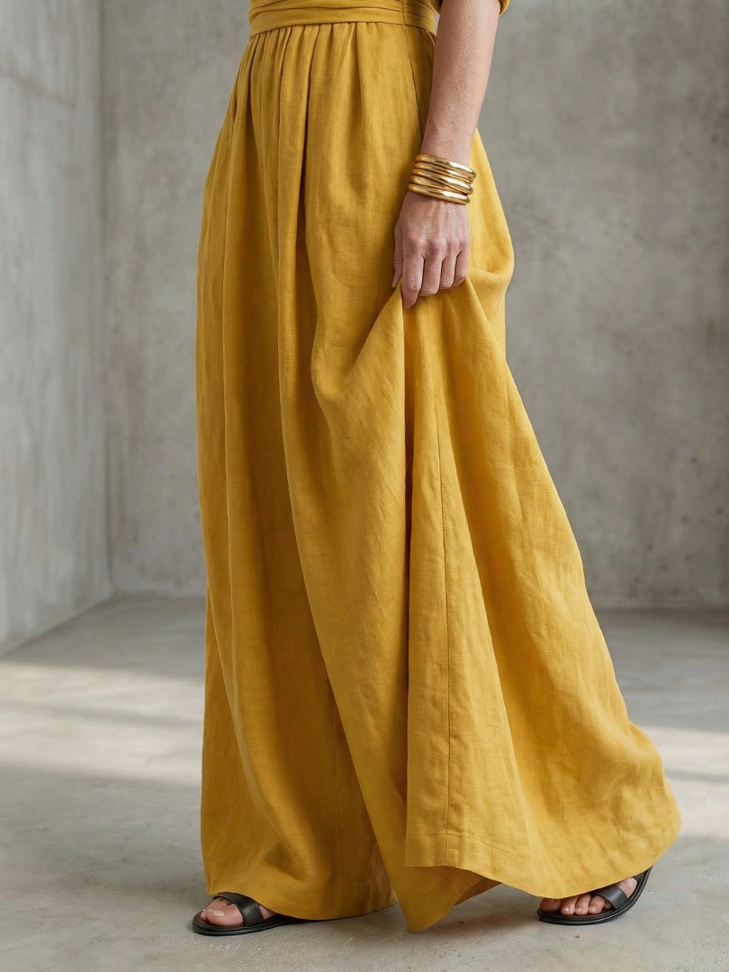 Yellow Wanda cross-front wide-leg jumpsuit by THE WHITMORE FAMILY, featuring a stylish cross-front design and wide-leg silhouette.