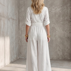 Yellow Wanda cross-front wide leg jumpsuit by THE WHITMORE FAMILY, featuring a stylish wide-leg silhouette and front design.