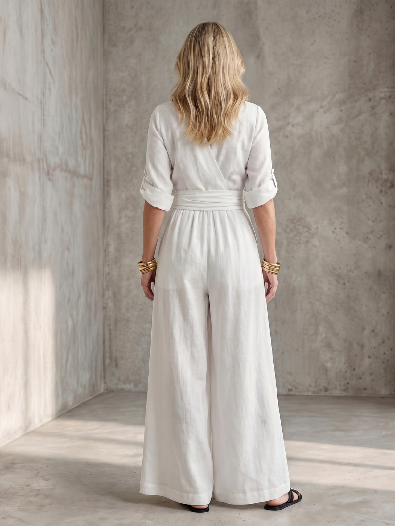 Yellow Wanda cross-front wide leg jumpsuit by THE WHITMORE FAMILY, featuring a stylish wide-leg silhouette and front design.