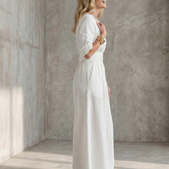 Yellow Wanda cross-front wide leg jumpsuit by THE WHITMORE FAMILY, featuring a stylish front design and wide-leg silhouette.