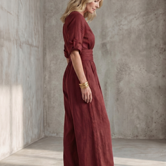 Yellow Wanda cross-front wide leg jumpsuit by THE WHITMORE FAMILY, featuring a stylish cross-front design and flowy wide-leg style.