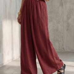 Yellow Wanda cross-front wide-leg jumpsuit by THE WHITMORE FAMILY, features a stylish cross-front design and flowing wide-leg fit.