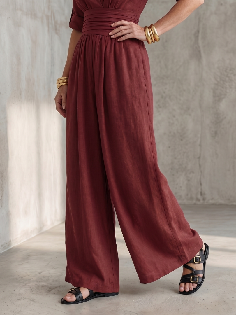 Yellow Wanda cross-front wide-leg jumpsuit by THE WHITMORE FAMILY, features a stylish cross-front design and flowing wide-leg fit.
