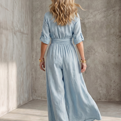 Yellow Wanda cross-front wide-leg jumpsuit by THE WHITMORE FAMILY, featuring a stylish cross-front design and flowing wide-leg pants.