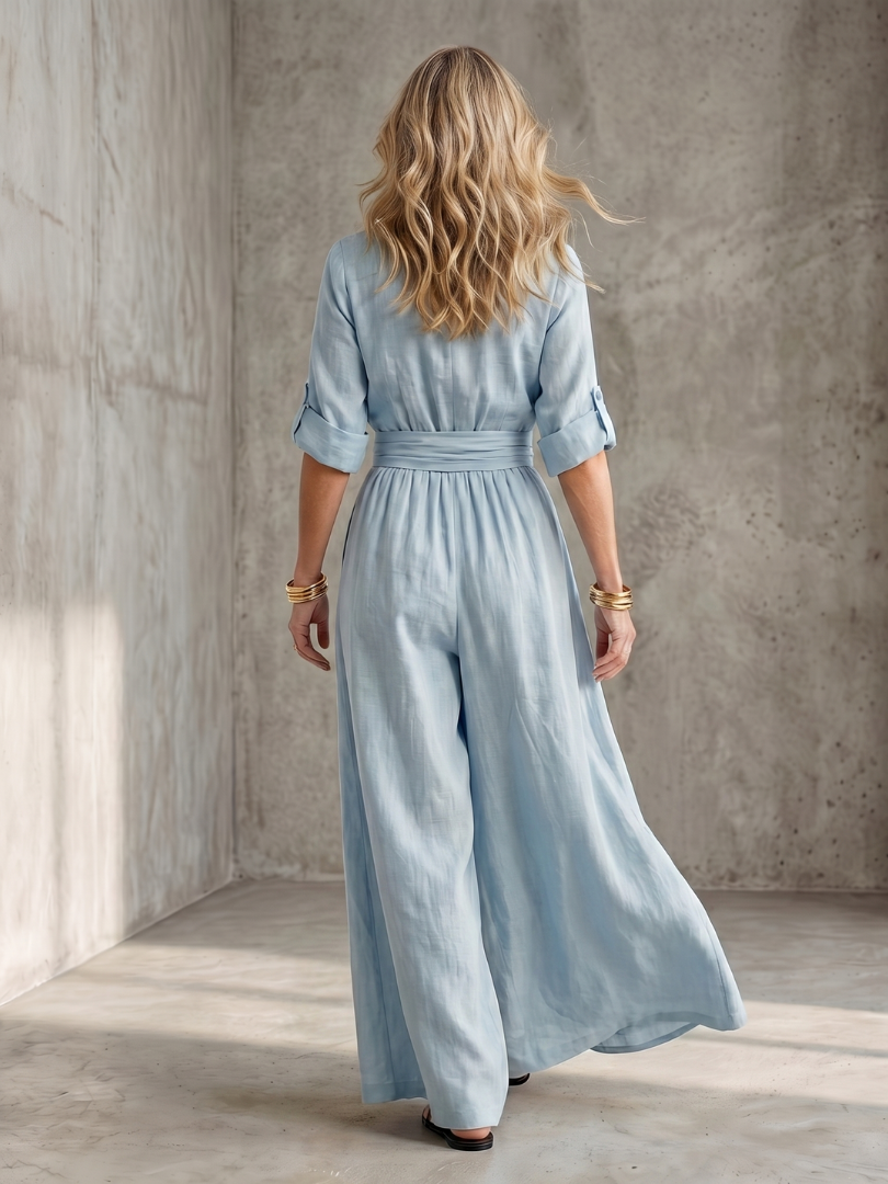 Yellow Wanda cross-front wide-leg jumpsuit by THE WHITMORE FAMILY, featuring a stylish cross-front design and flowing wide-leg pants.