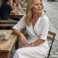 Yellow Wanda cross-front wide-leg jumpsuit by THE WHITMORE FAMILY, featuring a stylish front design and flowing wide-leg silhouette.