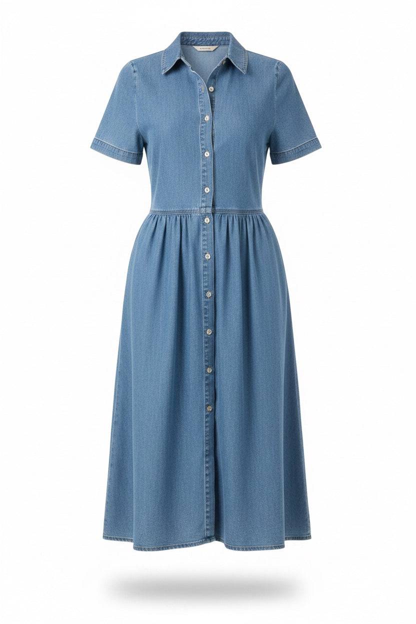 A model wearing the Aada™ Denim Dress by THE WHITMORE FAMILY, showcasing a stylish mid-length denim dress with a fitted waist.