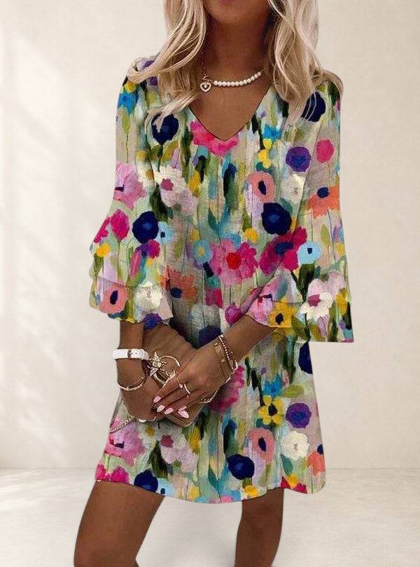 Elegant mini floral dress by THE WHITMORE FAMILY featuring a fitted silhouette and delicate floral pattern.