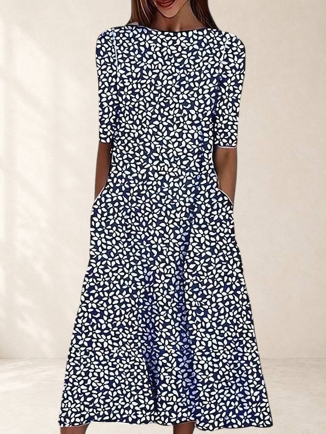 Navy floral midi dress by THE WHITMORE FAMILY, featuring elegant design and tailored fit, worn by a model.
