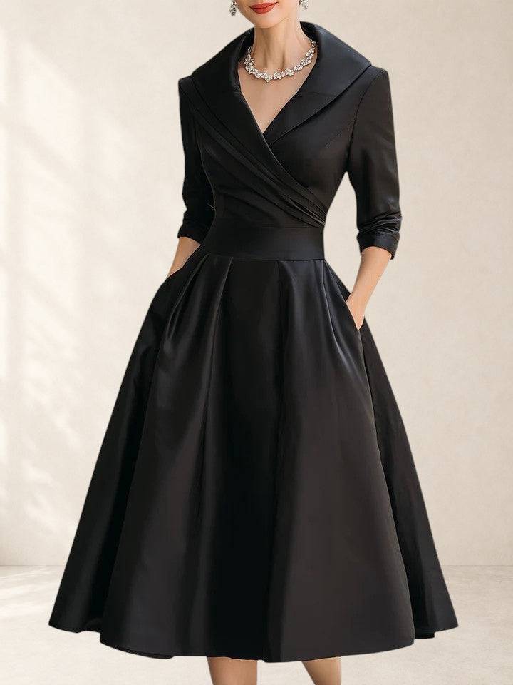 Black Yan elegant midi dress by THE WHITMORE FAMILY, featuring a fitted silhouette and stylish design, displayed on a model.