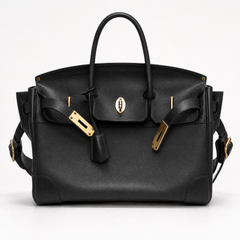 Black leather Eleanor Weekender bag by THE WHITMORE FAMILY showing front view with handles and spacious design.